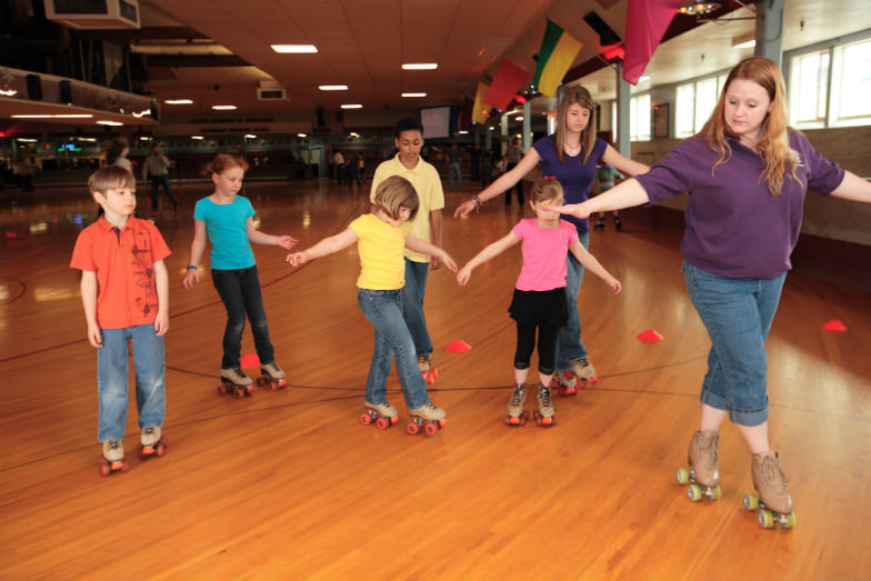 Kids learning to skate at Oaks Park Skating Rink in Portland