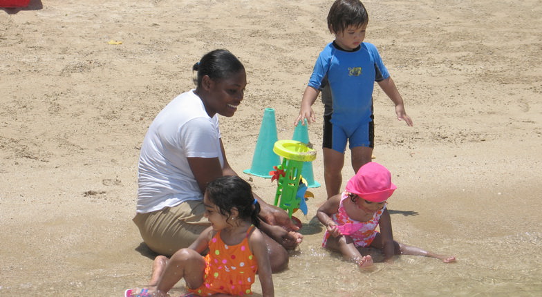 nanny and kids on the beach