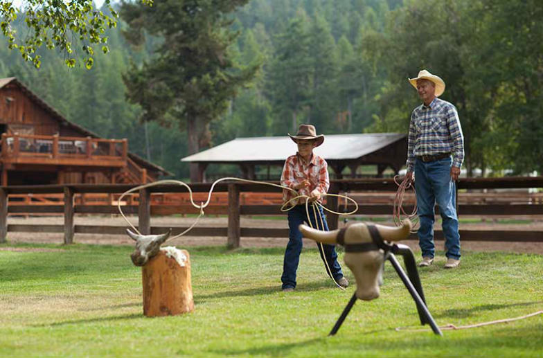 Stay at a dude ranch like Flathead Lake Lodge.